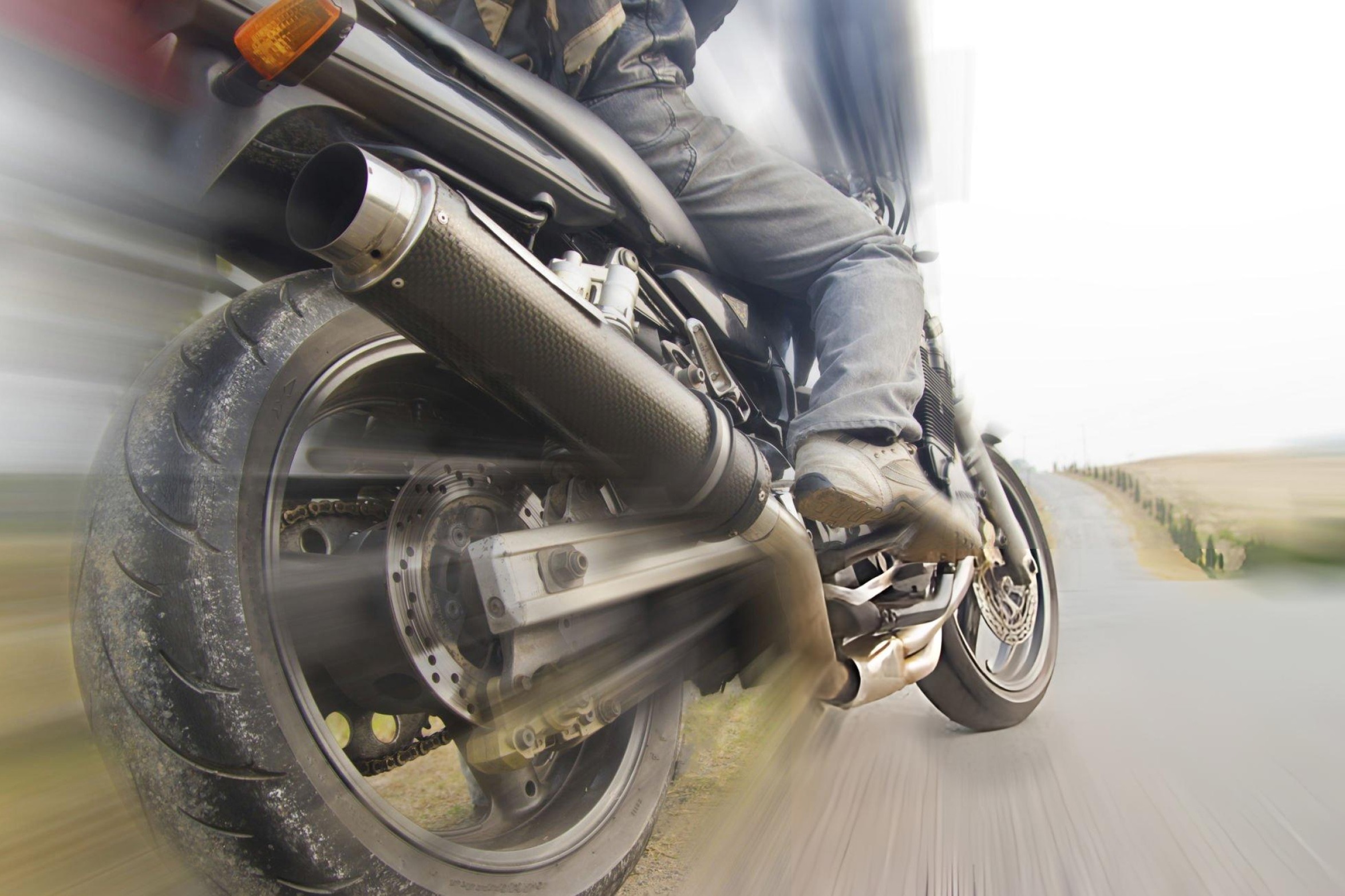 Motorcycle speeding on an open road, showcasing the high-speed capabilities of a 600cc sports bike.