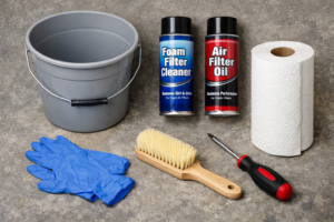 Dirt bike air filter cleaning kit with foam cleaner, filter oil, bucket, gloves, brush, and basic tools