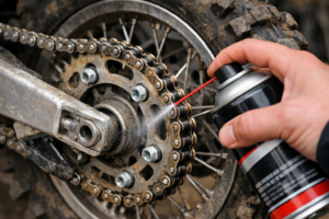 Inspecting dirt bike chain slack and lubricating the chain and rear sprocket before riding