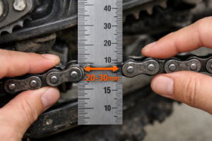 Measuring dirt bike chain slack at the midpoint in millimeters to set correct chain tension